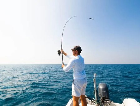 Angler casting from the stern of a sportfishing boat