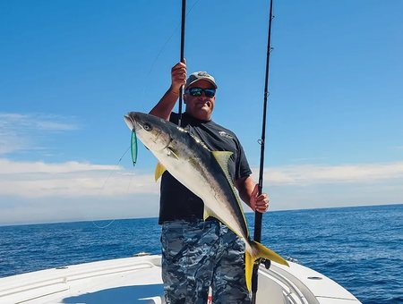 Angler holding a yellowtail catch